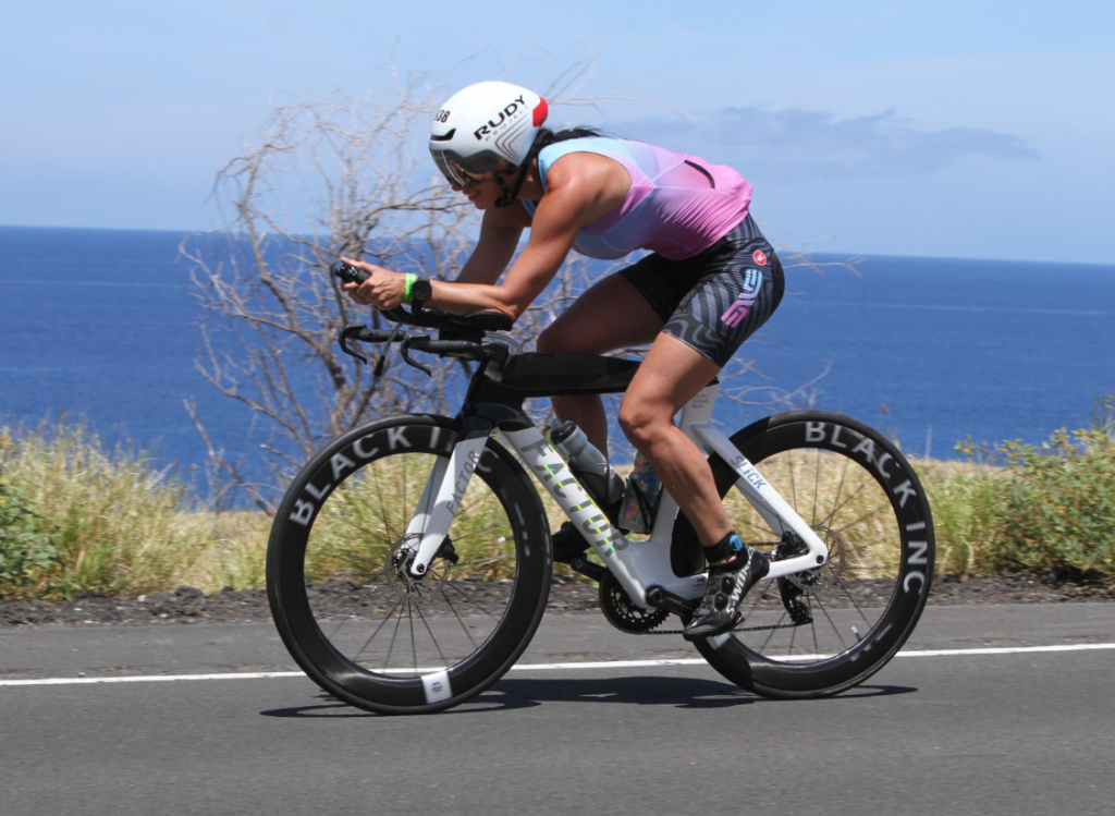 Triathlete cycling along the Kona coast during the Ironman World Championship bike course in Kona, Hawaii