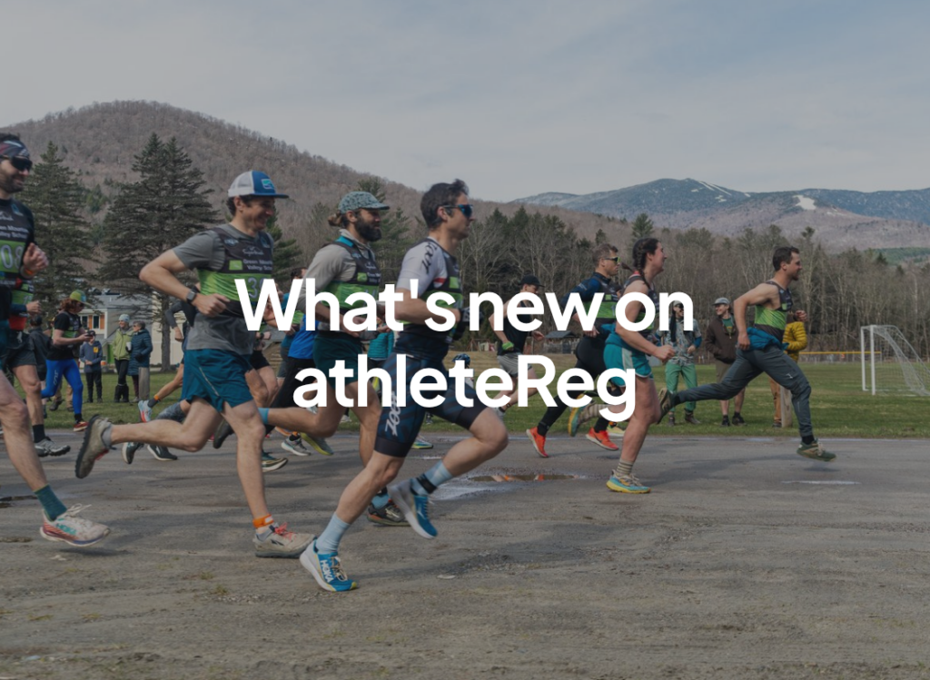 Group of runners at the start of a road race with mountain scenery in the background and "What's new on athleteReg" text overlay