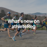 Group of runners at the start of a road race with mountain scenery in the background and "What's new on athleteReg" text overlay