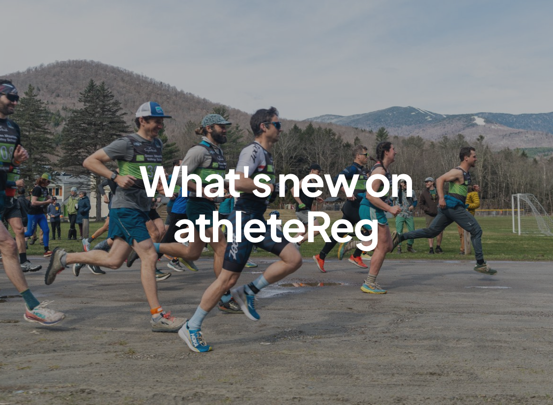 Group of runners at the start of a road race with mountain scenery in the background and "What's new on athleteReg" text overlay