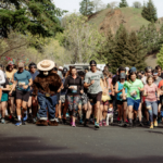Runners and Smokey Bear lead the charge at the Run with the Wild race start, a community event on athleteReg