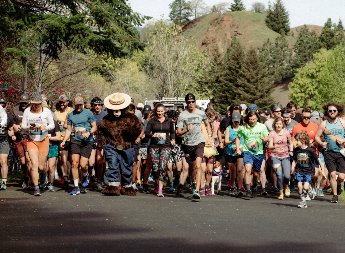 Runners and Smokey Bear lead the charge at the Run with the Wild race start, a community event on athleteReg